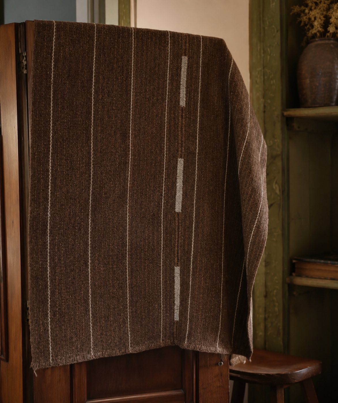 Dark brown handwoven fabric with cream pinstripe detail