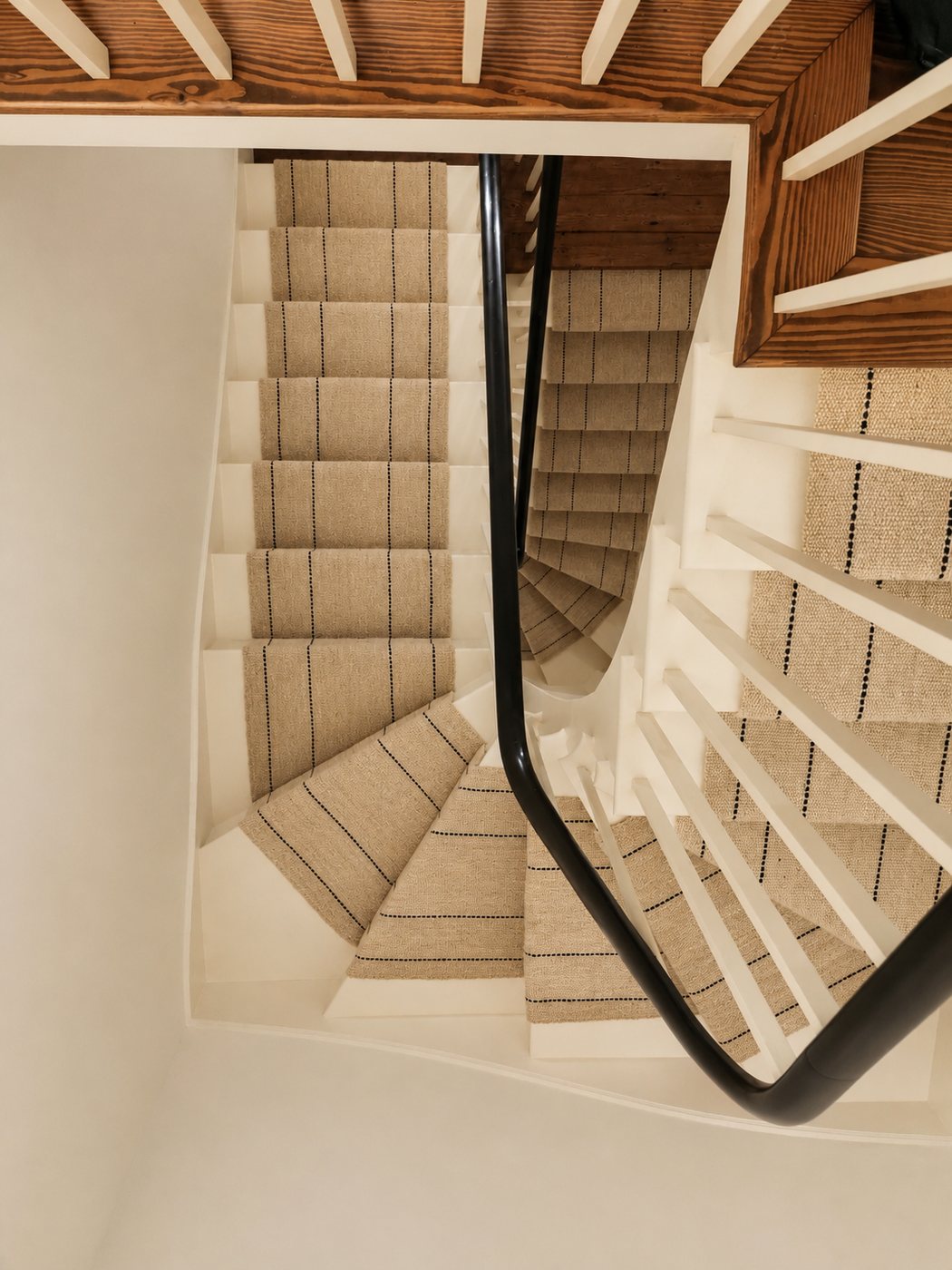Ecru with fine dark pinstripe handwoven goat hair stair runner on spiral staircase