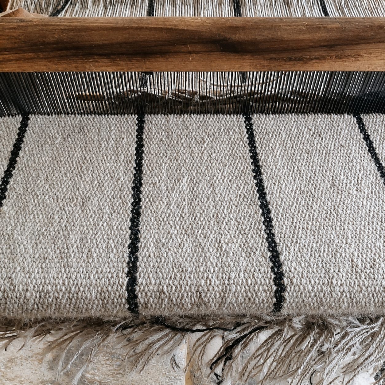 Close detail of handwoven goat hair rug on loom