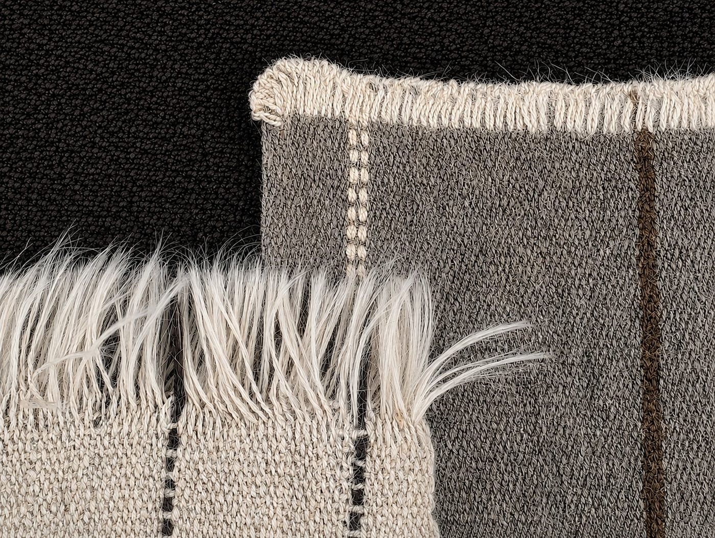 Coban rug end finishes — fringe and blanket stitch detail